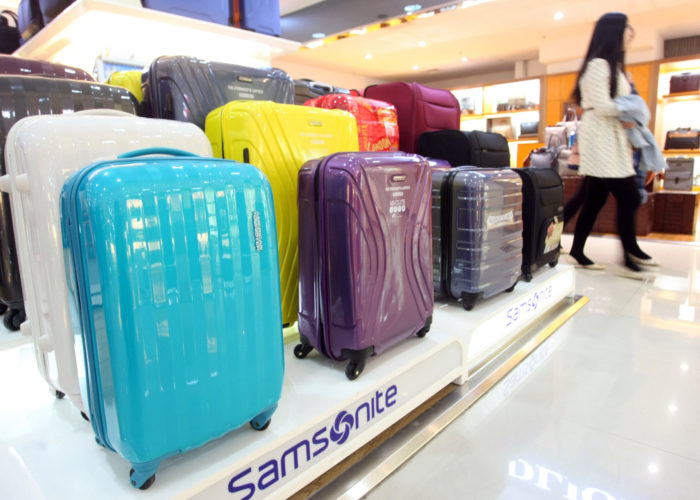 --FILE--Chinese shoppers walk past Samsonite luggages for sale at a department store in Shanghai, China, 27 March 2014.Luggage maker Samsonite expects its China sales growth to halve from the second half of the year, its head said on Wednesday (26 August 2015). China sales are expected to grow 15 to 16 percent on a local currency basis in the second half of the year and beyond, compared with nearly 30-percent growth in the first half, Chief Executive Ramesh Tainwala said. China, hit by slowing economic growth, accounts for about 10 percent of Samsonite's global sales. The company reported a 16.6-percent jump in sales in the first half of the year and an 8.9-percent rise in profit.